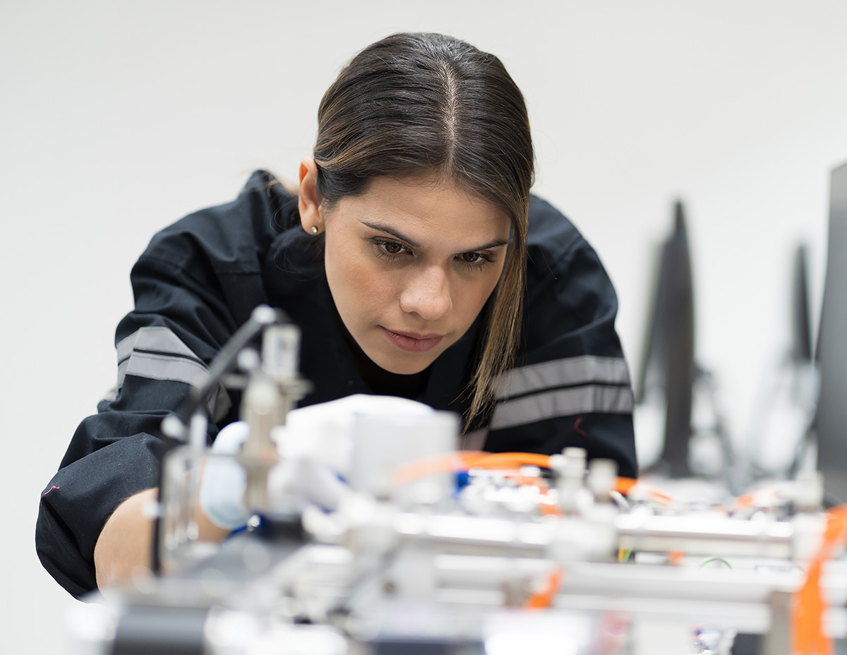 female car technician inspecting components